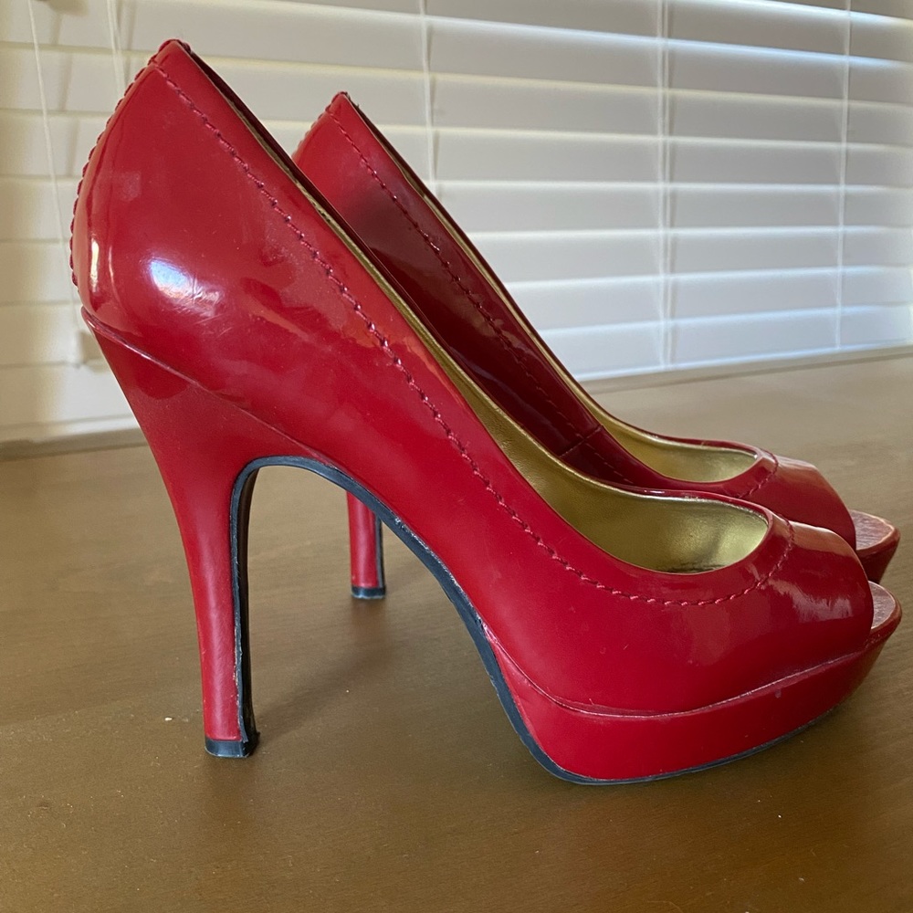 Candies red patent leather peep-toe heels.